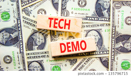 Tech demo symbol. Concept word Tech demo on beautiful wooden blocks. Dollar bills. Beautiful dollar bills background. Business tech demo concept. Copy space. Tech demo symbol. Concept word Tech demo on beautiful wooden blocks. Dollar bills. Beautiful dollar bills background. Business tech demo concept. Copy space. 135796715