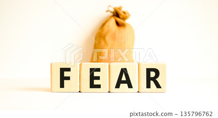 Fear symbol. Concept word Fear on beautiful wooden blocks. Beautiful canvas bag. Beautiful white table white background. Business, lifestyle and fear concept. Copy space. Fear symbol. Concept word Fear on beautiful wooden blocks. Beautiful canvas bag. Beautiful white table white background. Business, lifestyle and fear concept. Copy space. 135796762