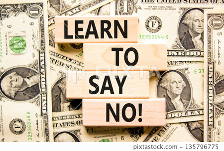 Learn to say no symbol. Concept words phrase Learn to say no on beautiful wooden blocks. Dollar bills. Beautiful dollar bills background. Business psychological Learn to say no concept. Copy space. 135796775