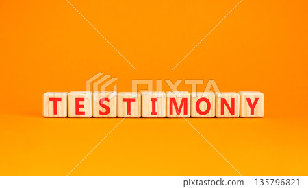 Testimony symbol. Concept word Testimony on beautiful wooden blocks. Beautiful orange background. Business education support testimony concept. Copy space. Testimony symbol. Concept word Testimony on beautiful wooden blocks. Beautiful orange background. Business education support testimony concept. Copy space. 135796821