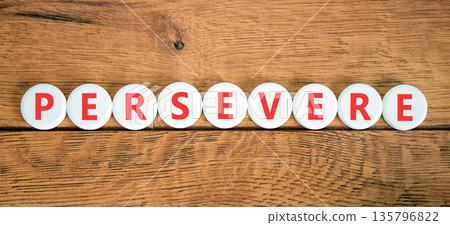 Persevere symbol. Concept word Persevere on beautiful white circles. Beautiful wooden background. Business education support persevere concept. Copy space. 135796822