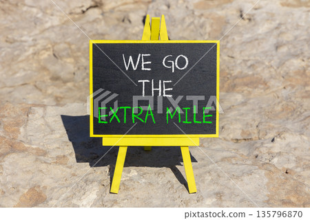 Support, help we go the extra mile symbol. Concept words We go the extra mile on beautiful blackboard. Beautiful stone background. Business we go the extra mile concept. Copy space. Support, help we go the extra mile symbol. Concept words We go the extra mile on beautiful blackboard. Beautiful stone background. Business we go the extra mile concept. Copy space. 135796870