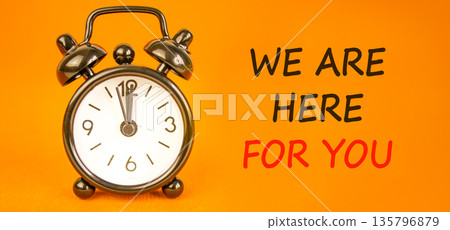 Support, help and we are here for you symbol. Concept words We are here for you on beautiful orange paper. Beautiful orange background. Alarm clock. Business we are here for you concept. Copy space. Support, help and we are here for you symbol. Concept words We are here for you on beautiful orange paper. Beautiful orange background. Alarm clock. Business we are here for you concept. Copy space. 135796879