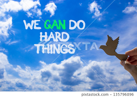 Support, help we can do hard things symbol. Concept words We can do hard things on beautiful sky. Beautiful blue sky background. Businessman's hand. Business we can do hard things concept. Copy space. 135796896