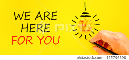 Support, help and we are here for you symbol. Concept words We are here for you on beautiful paper. Beautiful yellow background. Businessman's hand. Business we are here for you concept. Copy space. 135796898