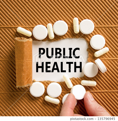 Public health symbol. Concept words Public health on beautiful white paper. White pills tablets. Doctor's hand. Beautiful brown background. Medical healthy lifestyle public health concept. 135796945