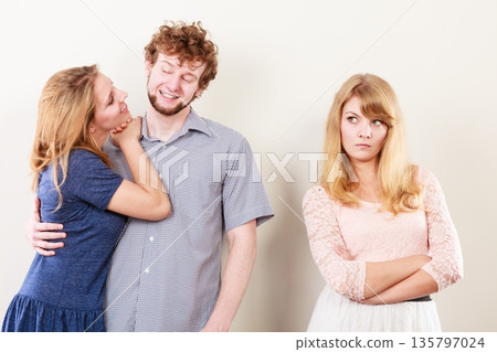 Jelous woman with happy couple 135797024