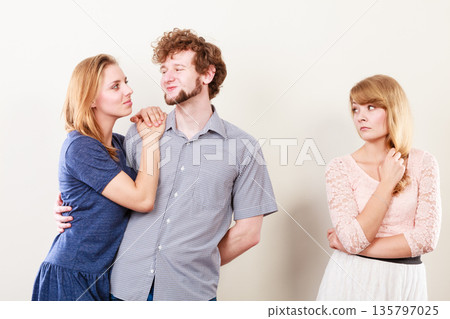 Jelous woman with happy couple 135797025
