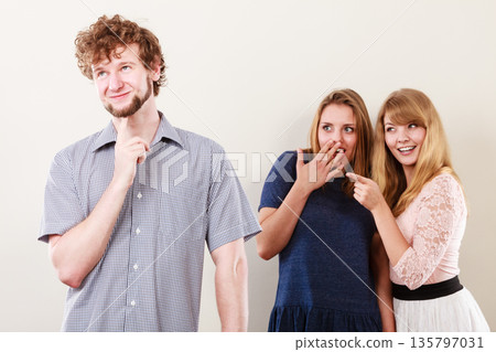 Two women talking gossiping about man. Two women talking gossiping about man. 135797031