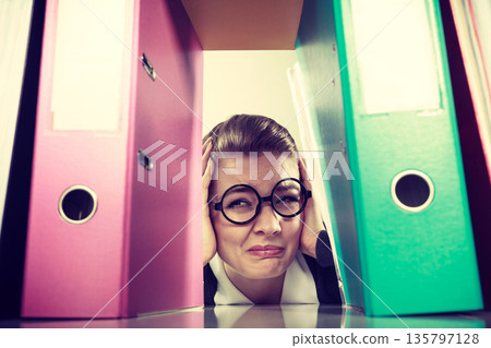 Accountant terrified of pils of binders. 135797128
