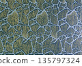 Muted blue cloth background with golden cracked ice pattern 135797324