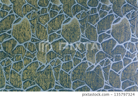 Muted blue cloth background with golden cracked ice pattern Muted blue cloth background with golden cracked ice pattern 135797324