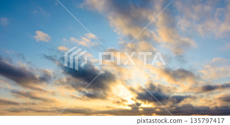 blue sky background with clouds. nature in summer at sunrise. dynamic cloudscape above horizon in morning light. nice image for beautiful outdoor wallpaper blue sky background with clouds. nature in summer at sunrise. dynamic cloudscape above horizon in morning light. nice image for beautiful outdoor wallpaper 135797417