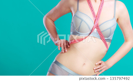 Woman in underwear with measure tape Woman in underwear with measure tape 135797492