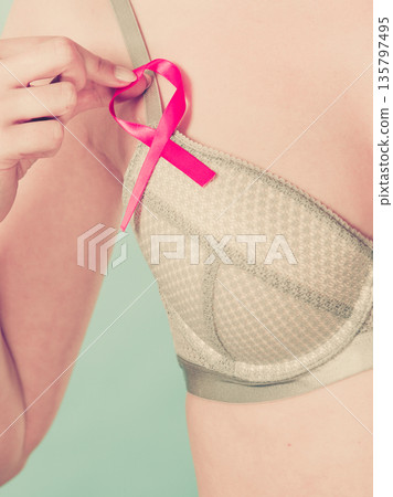 woman in bra with breast cancer awareness ribbon 135797495