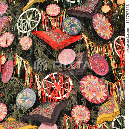 Decorations of Maslenitsa holidays: Pavlovsky Posad shawls, colorful ribbons, plates with ornament, and festive symbol of Shrovetide - the Sun Decorations of Maslenitsa holidays: Pavlovsky Posad shawls, colorful ribbons, plates with ornament, and festive symbol of Shrovetide - the Sun 135797538