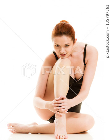 Sitting woman in underwear showing smooth legs 135797563
