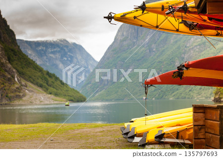 Many canoes on norwegian fjord shore 135797693
