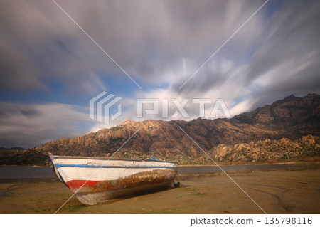 Fishing boats moored along the shore of Lake Bafa in Turkey. Long Exposure shoot. tranquility scene. Fishing boats moored along the shore of Lake Bafa in Turkey. Long Exposure shoot. tranquility scene. 135798116
