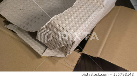 Packaging goods in paper packaging. Careful and eco-friendly production and delivery of goods. High quality photo Packaging goods in paper packaging. Careful and eco-friendly production and delivery of goods. High quality photo 135798148