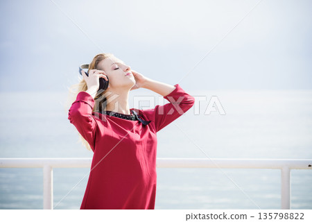Woman wearing headphones outdoor 135798822