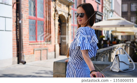 Tourist woman in striped dress in Gdansk Old Town Poland 135800055