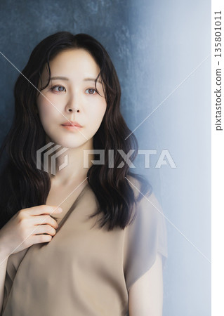 A woman by the window 135801011