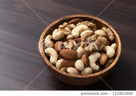 Mixed nuts in a wooden bowl Mixed nuts in a wooden bowl 135801600