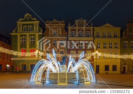 Poznan Old Market Square with illuminated fountain and colorful buildings Poznan Old Market Square with illuminated fountain and colorful buildings 135802272