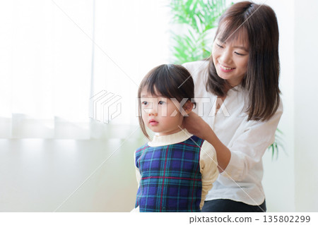 母親正在幫女兒綁頭髮 135802299