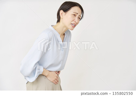 Woman in her 40s, abdominal pain, white background 135802550
