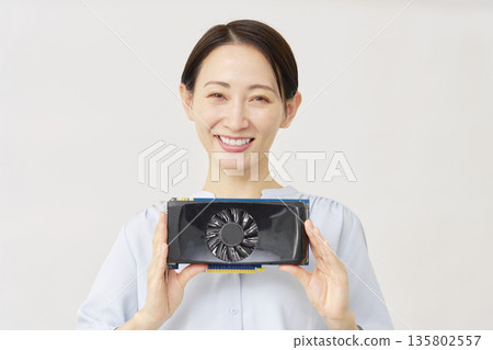 A woman in her 40s holding a graphics board on a white background 135802557