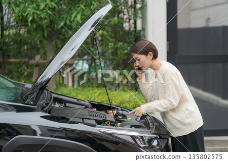 A woman calling because her car broke down 135802575