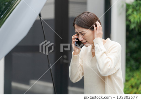 A woman calling because her car broke down 135802577