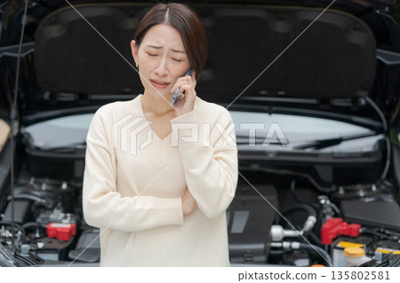 A woman calling because her car broke down A woman calling because her car broke down 135802581