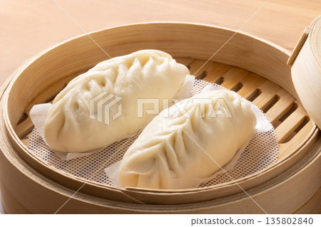 Steamed gyoza dog in a bamboo steamer Steamed gyoza dog in a bamboo steamer 135802840