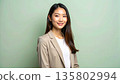 一張從肩後拍攝的職業肖像照，展現了一位沉著冷靜、專業幹練的年輕女性。 135802994