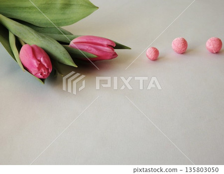Tulips and crepe paper balls on a white background Tulips and crepe paper balls on a white background 135803050
