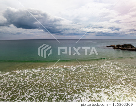 Dark clouds over sea nature beach background 135803369