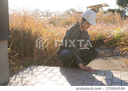 Workers looking at used properties 135804599