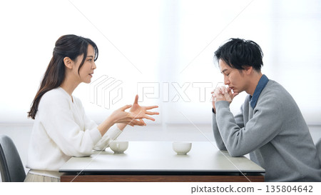 A male and female couple talking in a room A male and female couple talking in a room 135804642