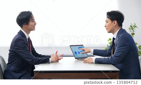 A group of male business people having an interview in an office 135804712
