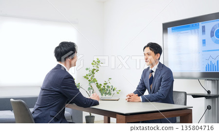 A group of male business people having an interview in an office 135804716