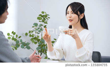 A male and female couple talking in a room A male and female couple talking in a room 135804735