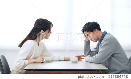 A male and female couple talking in a room A male and female couple talking in a room 135804738
