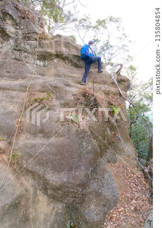 Climbers climbing the rocky terrain of Mount Takato in Chiba Prefecture 135804854