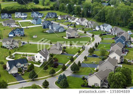 Low-density two story private homes in rural residential suburbs outside of Rochester, New York. Upscale suburban houses with large lot size and green grassy lawns in summer season 135804889