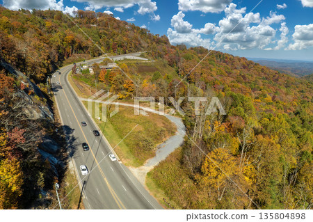 Freeway road with fast moving traffic cars and trucks in North Carolina Appalachian mountains in fall season. Interstate transportation infrastructure in USA Freeway road with fast moving traffic cars and trucks in North Carolina Appalachian mountains in fall season. Interstate transportation infrastructure in USA 135804898