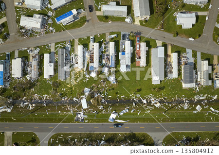Severely damaged houses after hurricane Ian in Florida mobile home residential area. Consequences of natural disaster 135804912