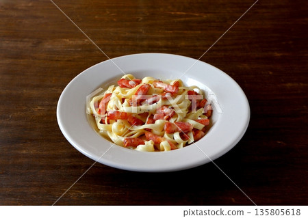 Tagliatelle carbonara on the table background Tagliatelle carbonara on the table background 135805618